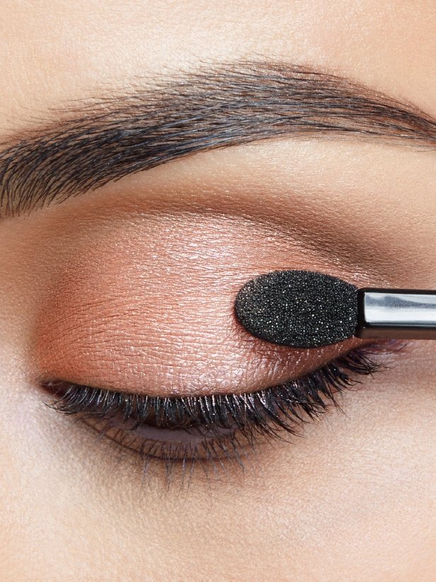 Woman applying Eye bronze shade from The Blushed Nudes Palette on Eyelid