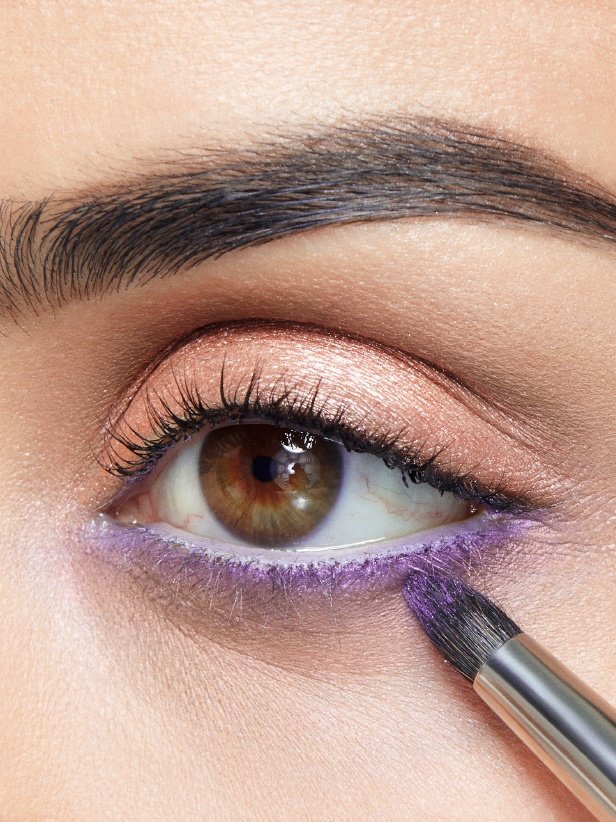 Woman Applying Eyestudio Color Tattoo 24HR Cream Gel Eye Shadow ‘Painted Purple’ on lower lash line