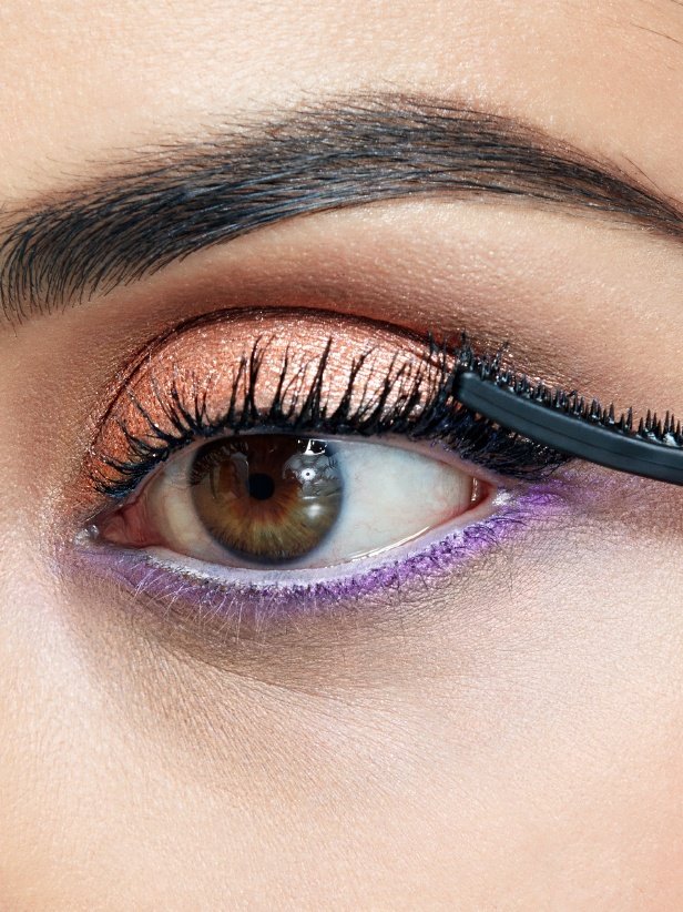 Woman applying Falsies Push Up Angel Mascara